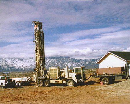 A WM Blain drill rig at work on a Northern Nevada well, with the Sierra Nevada behind it